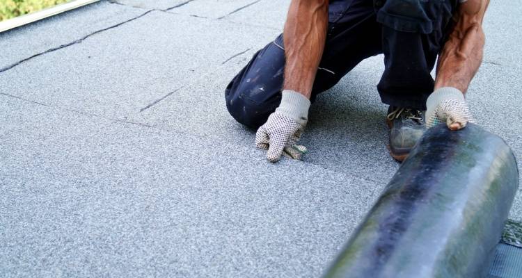 person installing flat roof