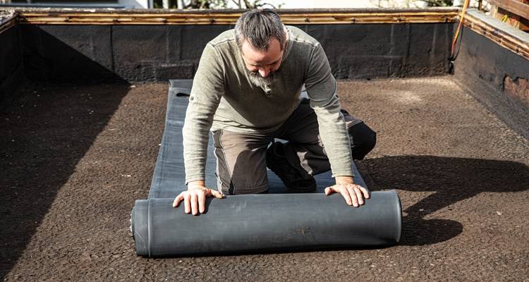 man rolling out rubber
