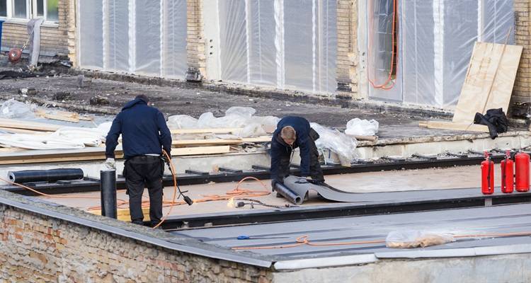 men replacing roof