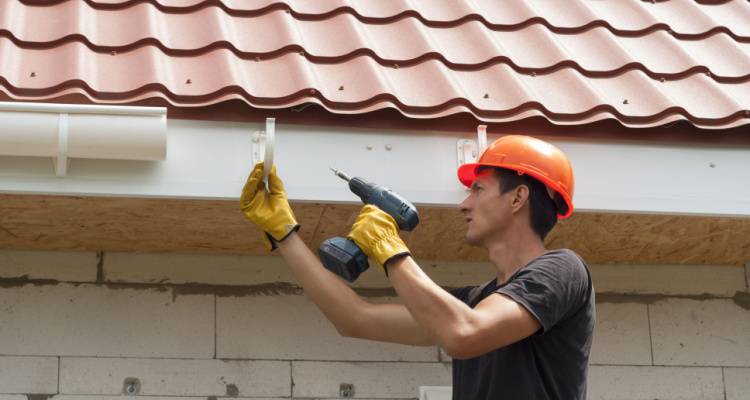 person fixing gutters