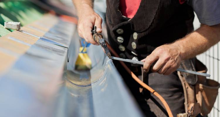 man fixing a gutter