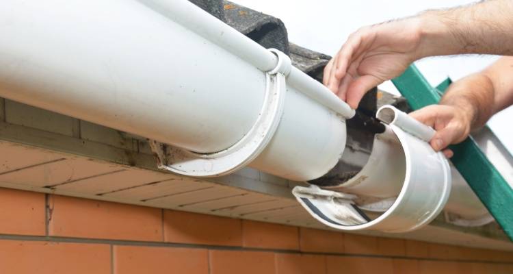 person replacing guttering