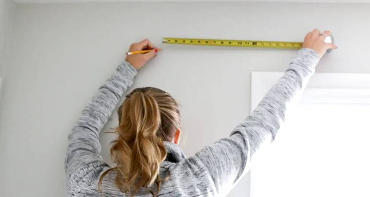 Woman measuring window