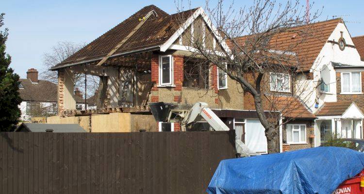 house extension cost guide — a large extension in the process of being added to a UK property