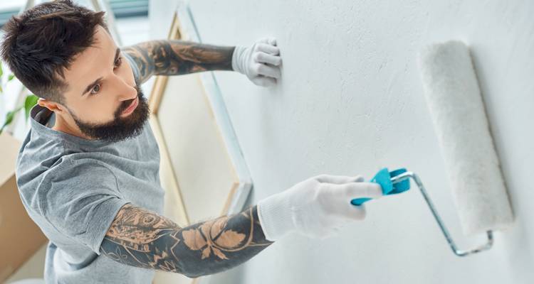 Man painting white walls