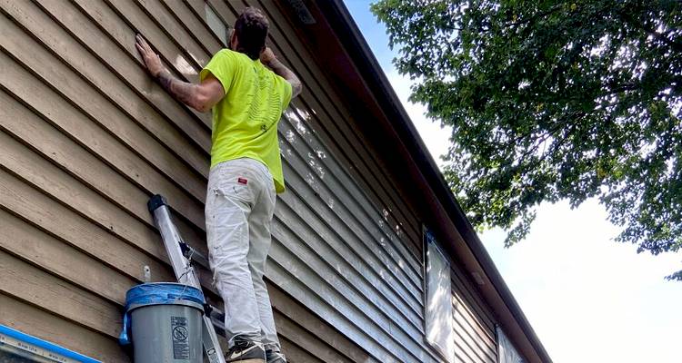 Man painting house exterior