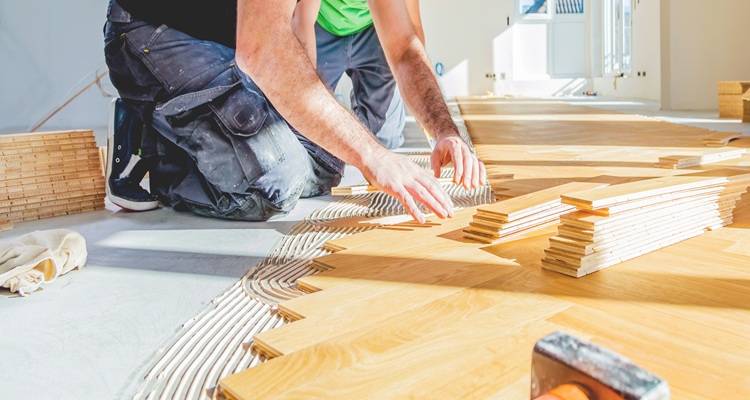 man laying flooring