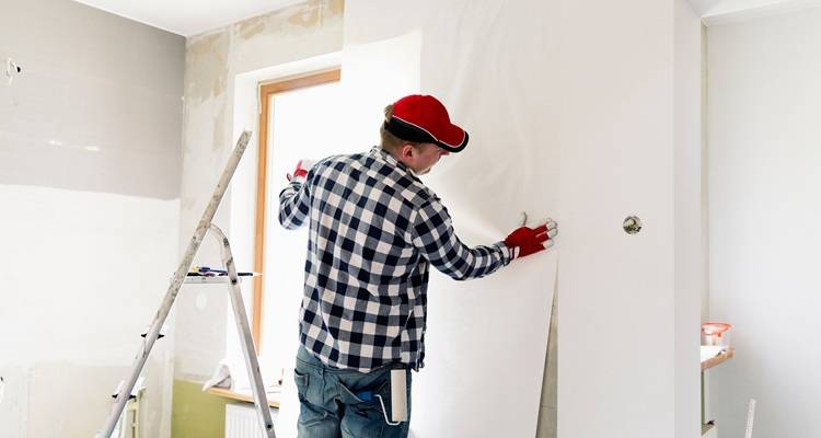 man hanging white paper