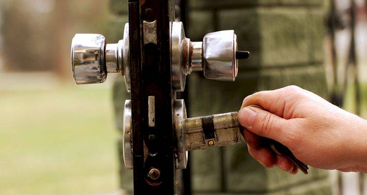 locksmith cost guide — closeup of locks being changed on a door