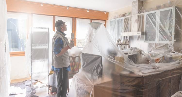 man holding brush kitchen covered