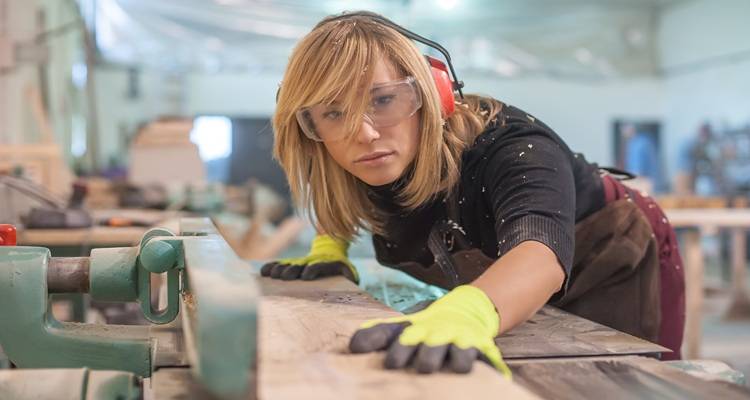 woman cutting wood
