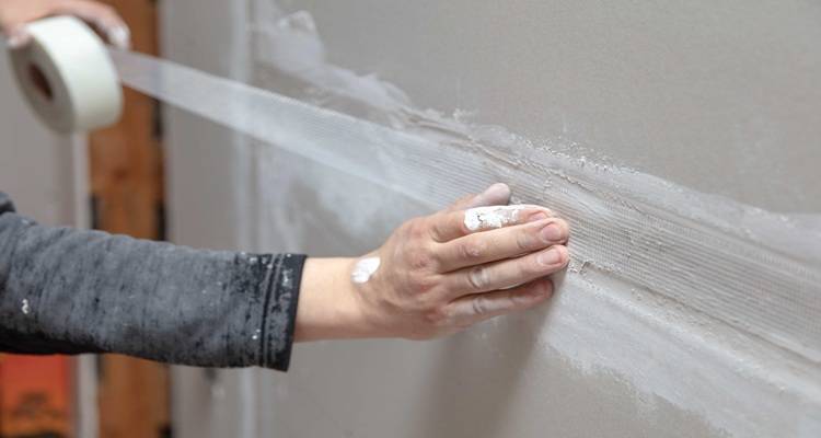 man with plastering tape