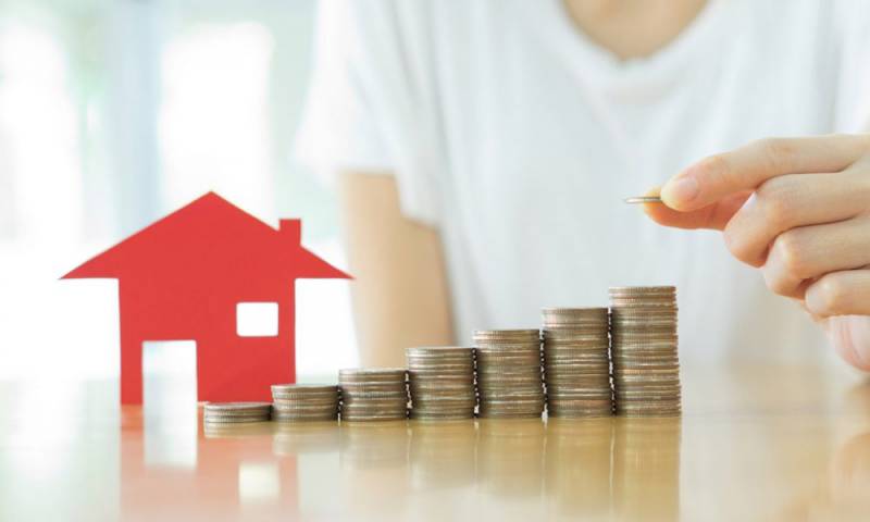 small model Red house with stacks of coins