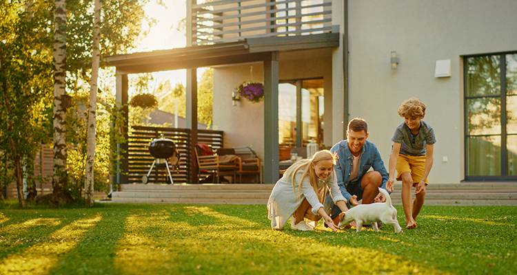 family and pet playing in garden