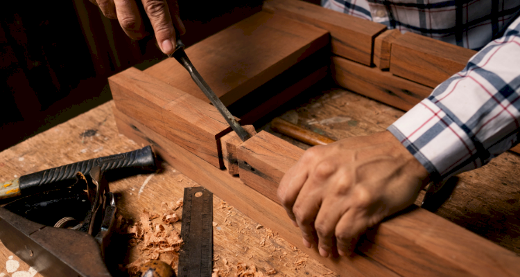 Man sanding down a chair