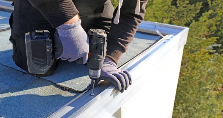 person replacing flat roof