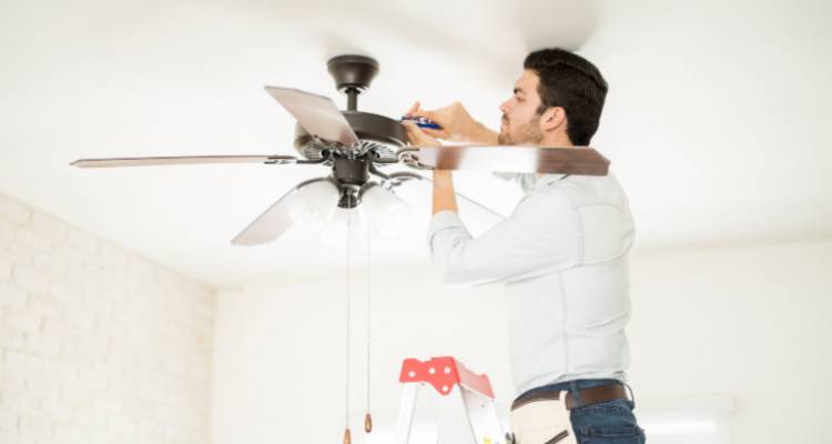 person installing ceiling fan