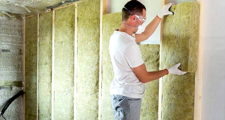 ground source heat pump cost guide — cavity wall insulation being installed by a tradesperson