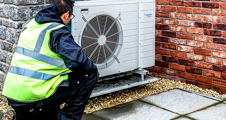 Man installing ground source heat pump