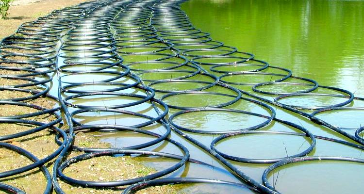 ground source heat pump cost guide — heating coils laid on floor outside