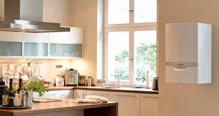 combi boiler installation cost guide — combi boiler that has been installed on the wall of a kitchen
