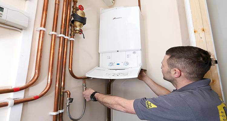 combi boiler installation cost guide — tradesperson installing a combi boiler