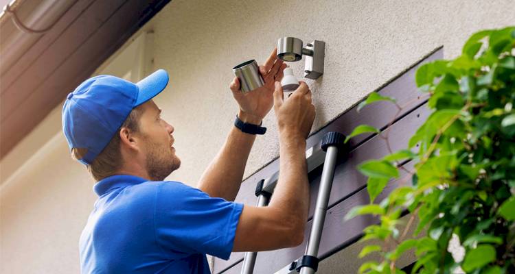 blue shirt man installing light