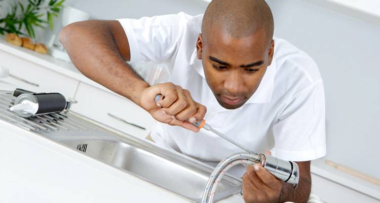 Man fitting kitchen taps