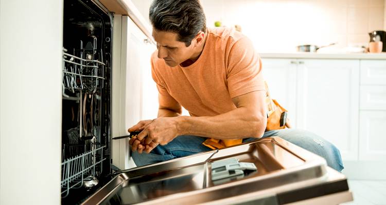 Man repairing dishwasher
