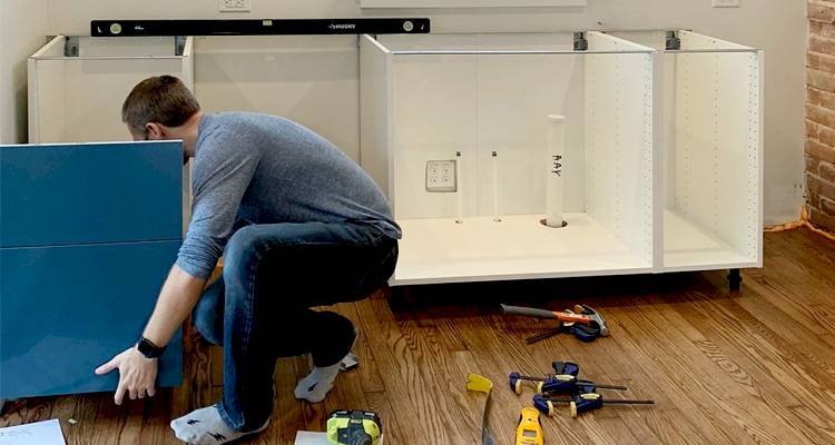 Man installing kitchen cupboards