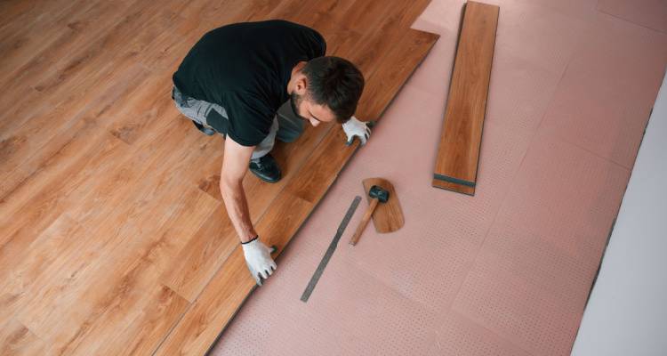 person fitting new laminate flooring