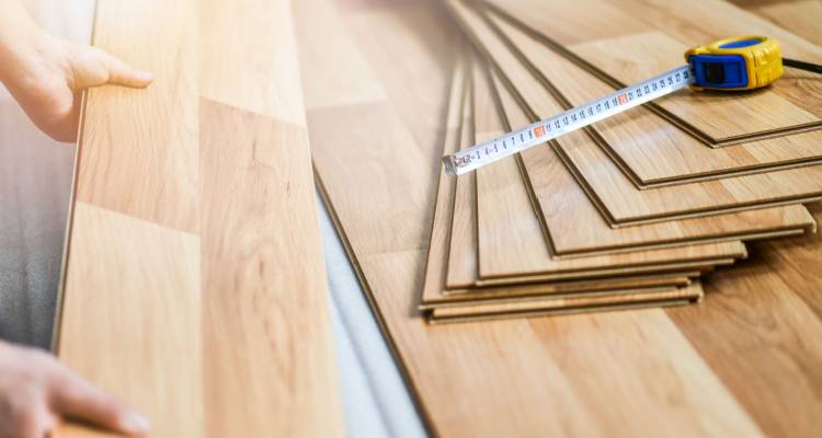 person fitting laminate flooring