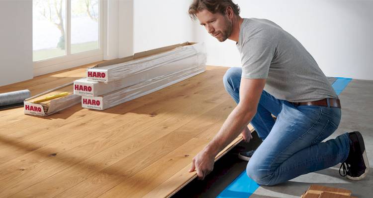 man laying wood floor