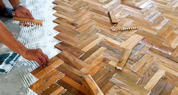 man laying wood floor