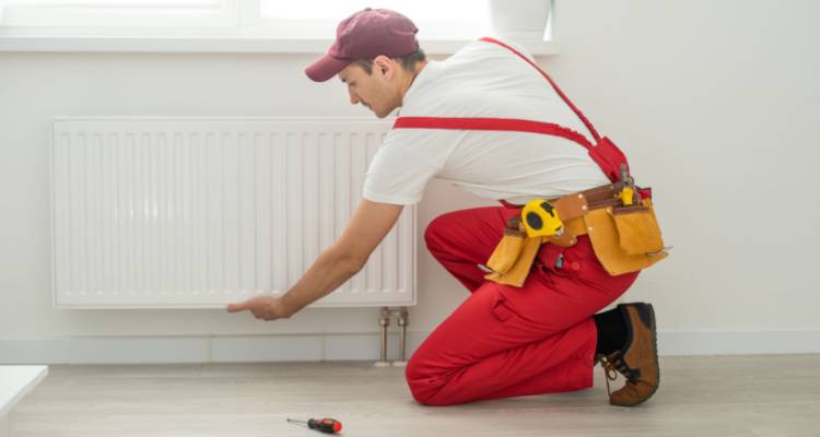 person installing a radiator