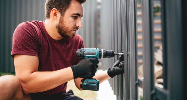 man installing fence