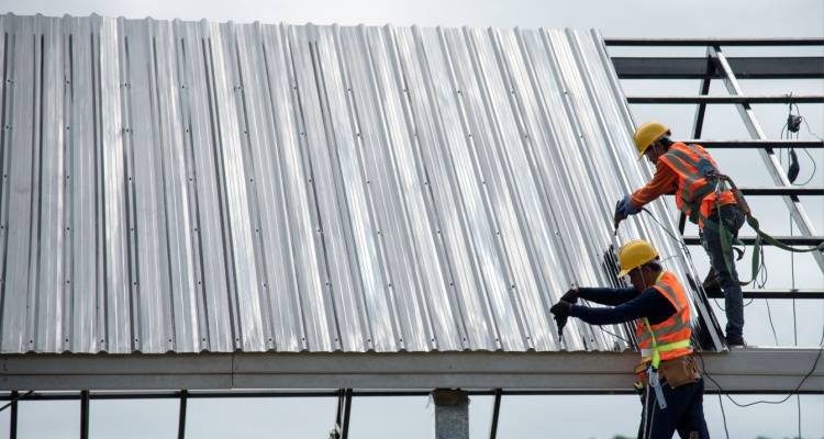 person working on metal roof