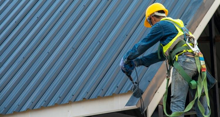 person working on metal roof