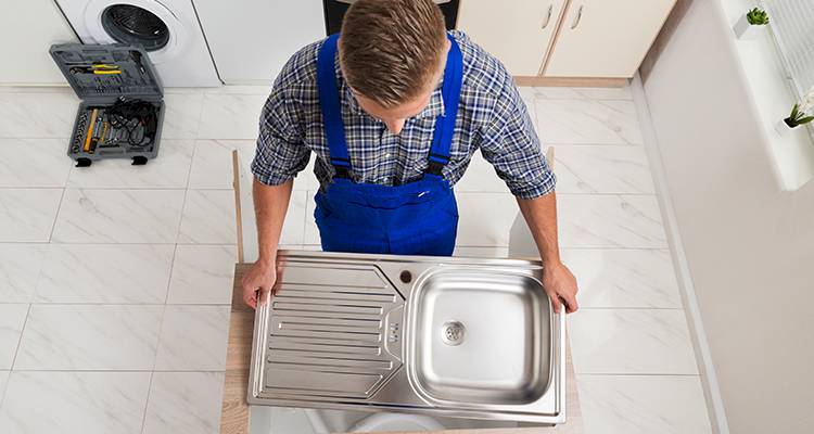 Man fitting sink