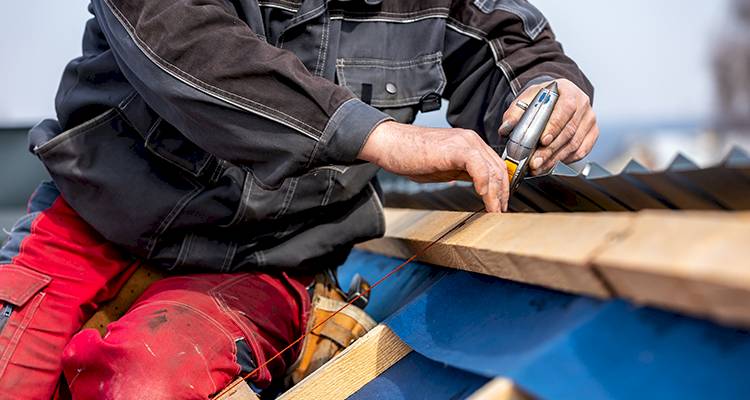 workman red trousers fitting roof