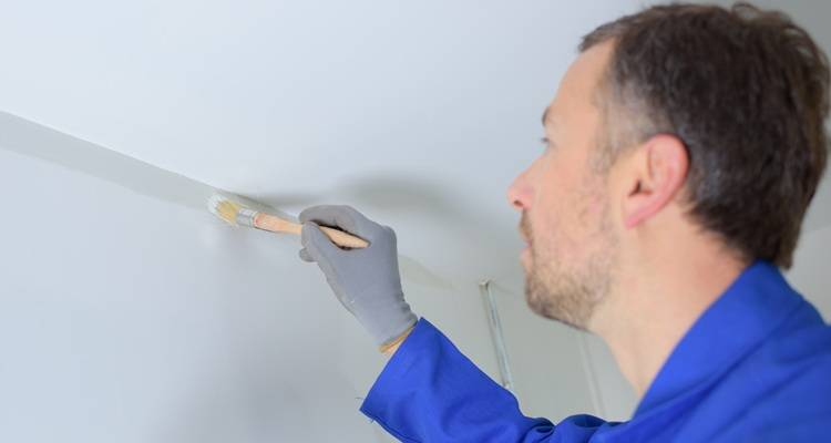 man cutting in paint