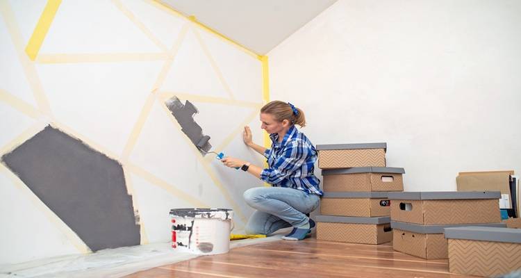woman painting geometric shapes