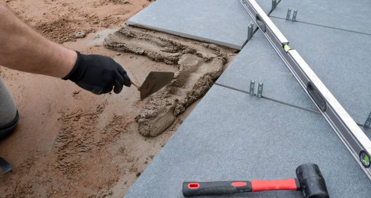 someone laying patio flags