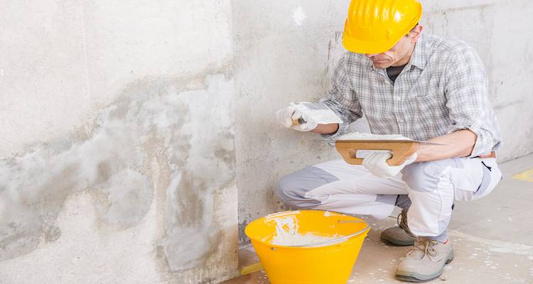 tradesperson fixing a wall