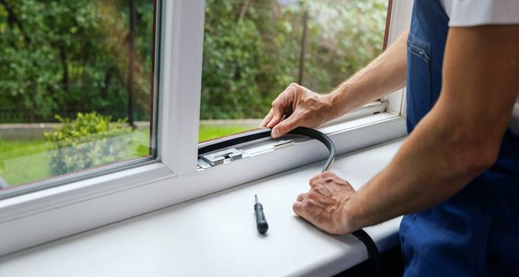 man insulating window
