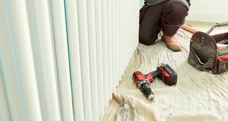 Tradesperson installing a radiator