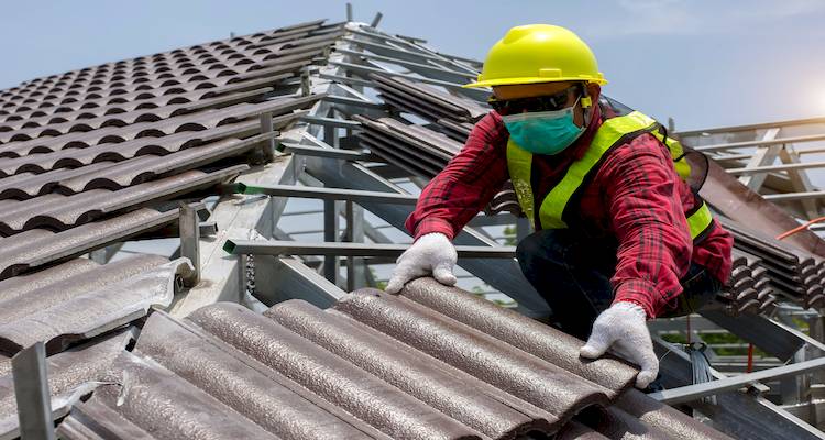 tradesperson who is fitting a new roof