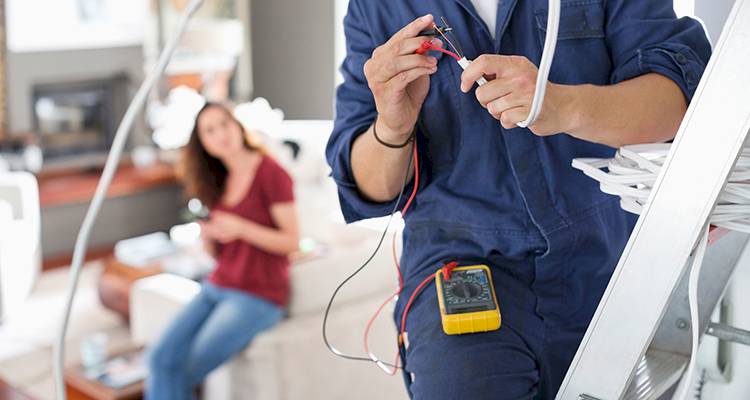 electrician rewiring in a UK living room