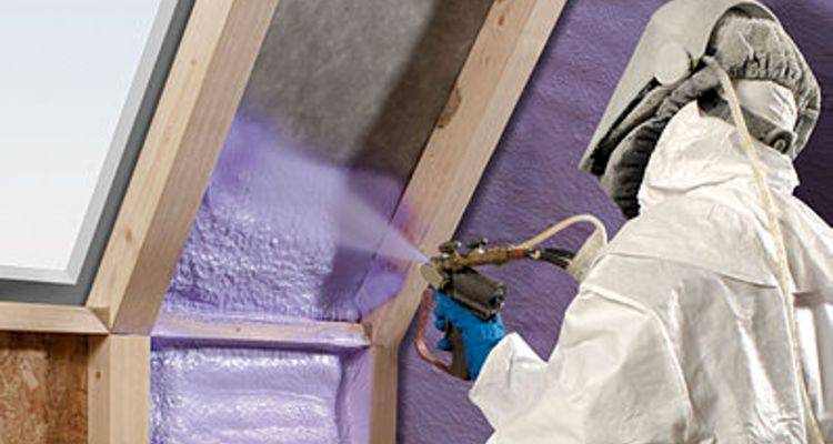 roof insulation cost guide — expanding foam insulation being applied by a specialist