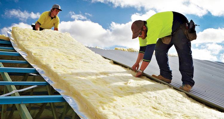 Roofers installing insulation